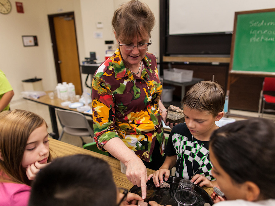 Hilary Olsen in classroom with children